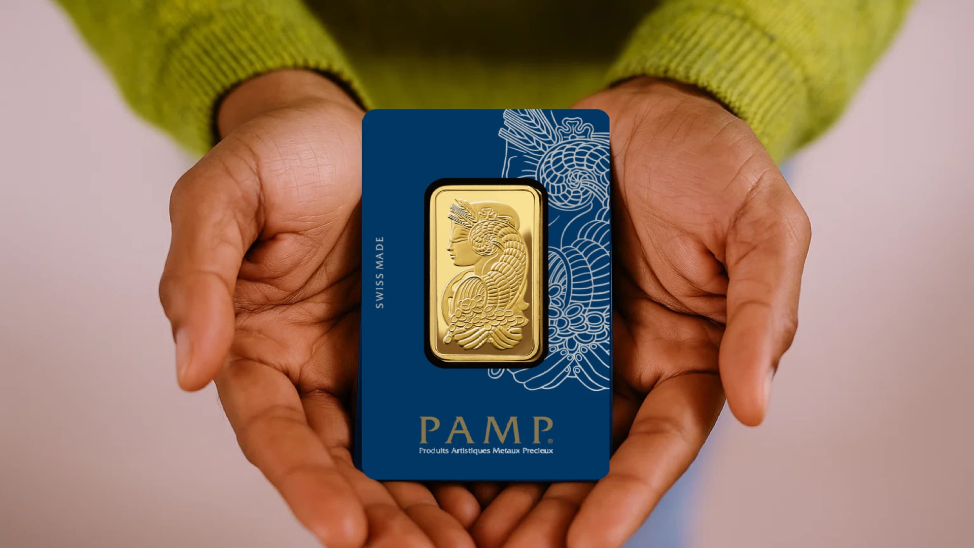 1 oz PAMP Suisse Fortuna gold bar in sealed assay card held in hands