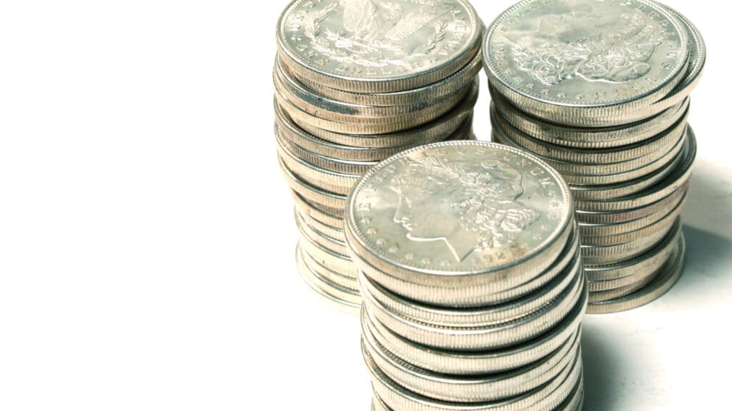 Stacked Morgan silver dollars showing obverse and reverse designs