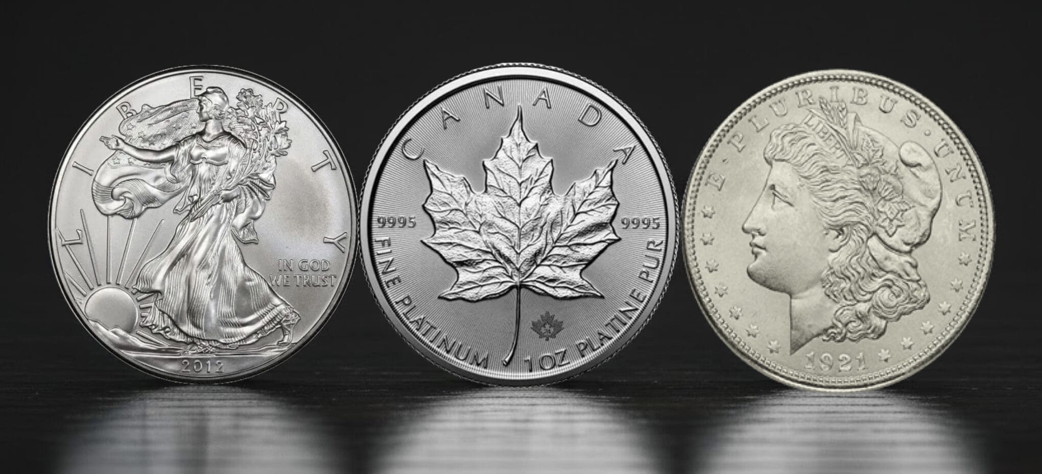 Silver and platinum coins on wooden surface