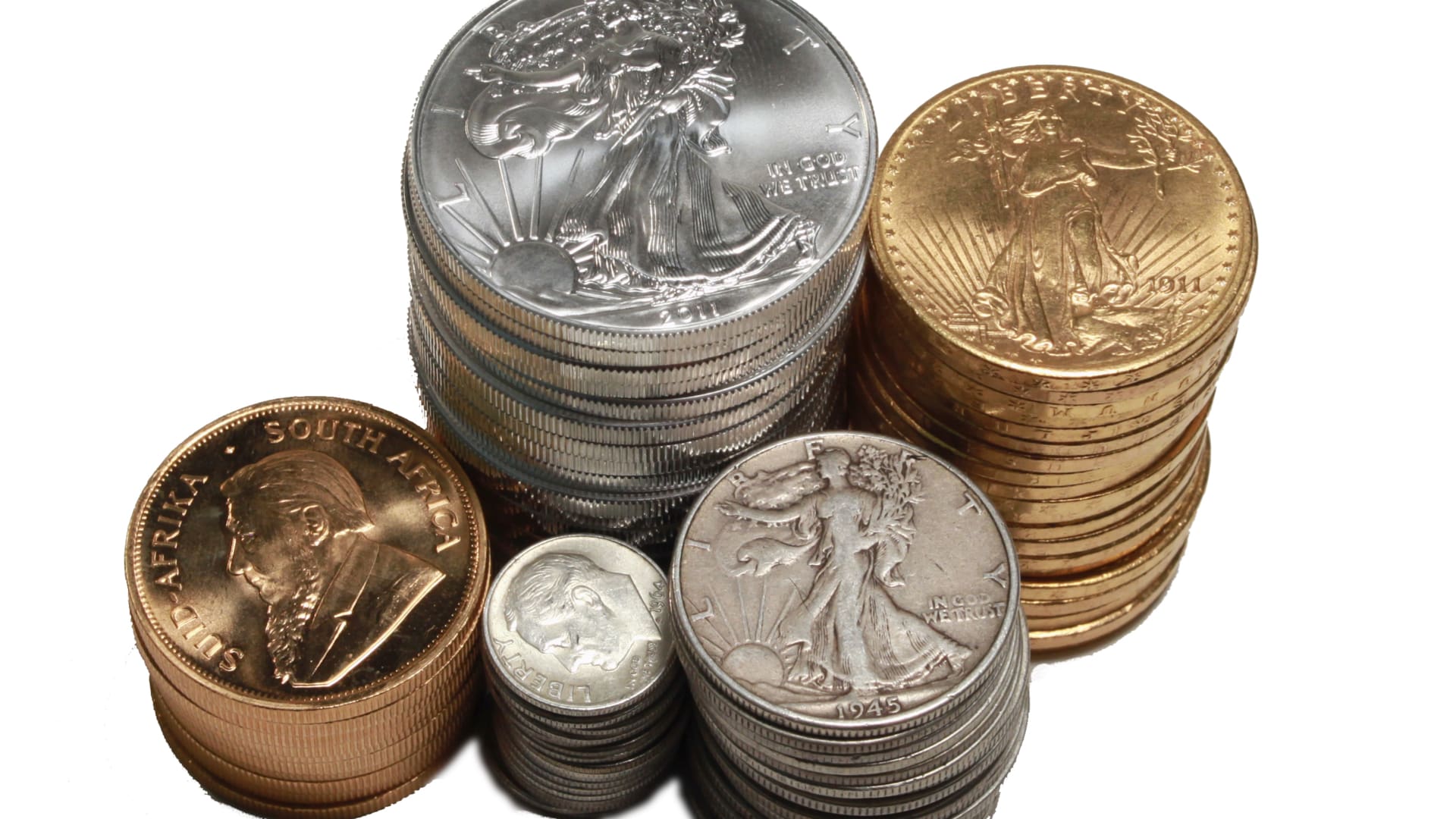 Stacks of gold and silver coins including Eagles, Krugerrands, and classic U.S. pieces