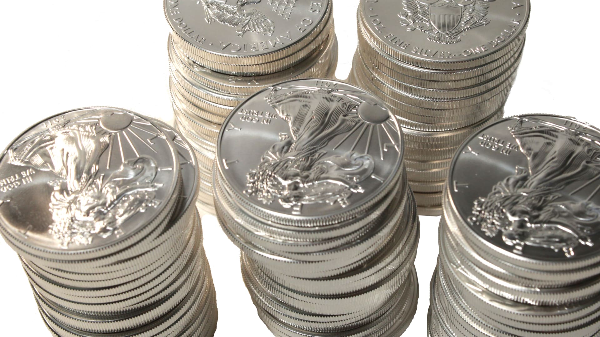 Stacks of American Silver Eagle coins showing individual silver coins often compared to monster box purchases