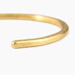 Close up view of a single 1 oz gold bracelet made from .999 fine gold